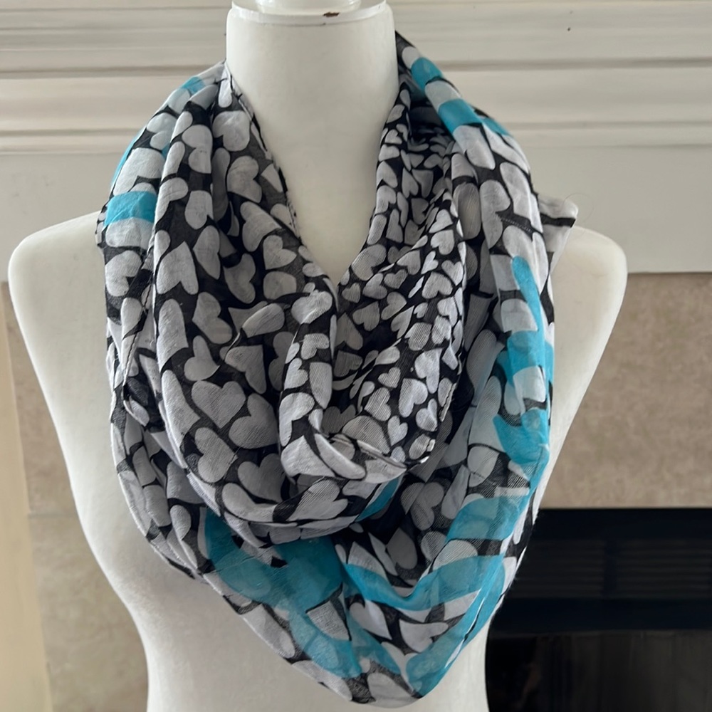 Pretty infinity scarf with white hearts on black back ground with bright blue.